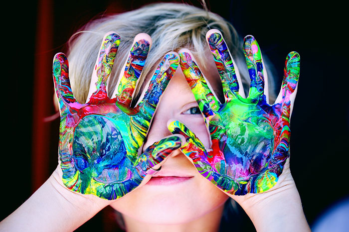 kid hand with washable paint