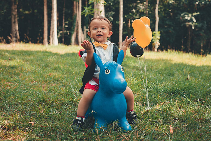 kid playing with ride on toy