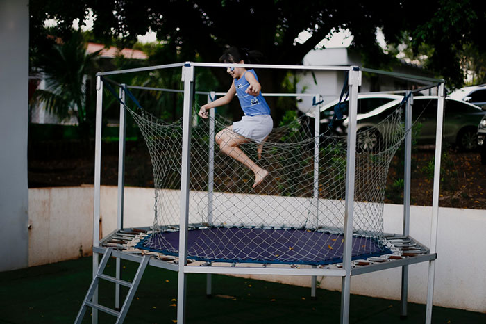 kid jumpin on a trampoline