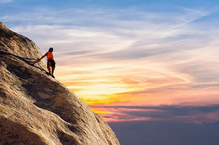 Highly motivated person climbing a mountain