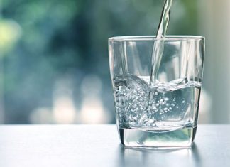 Adobe Stock royalty-free image #159675117, 'Close up the pouring purified fresh drink water from the bottle on table in living room' uploaded by Cozine, standard license purchased from https://stock.adobe.com/images/download/159675117; file retrieved on November 26th, 2018. License details available at https://stock.adobe.com/license-terms - image is licensed under the Adobe Stock Standard License