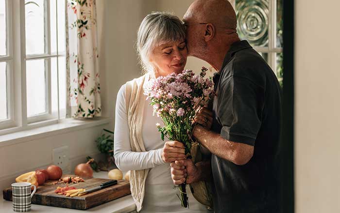 Senior Couple Giving a Flower
