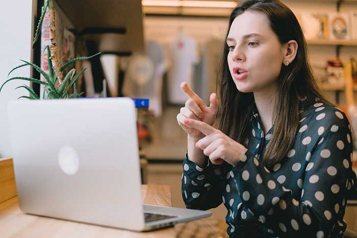 girl pointing to a laptop