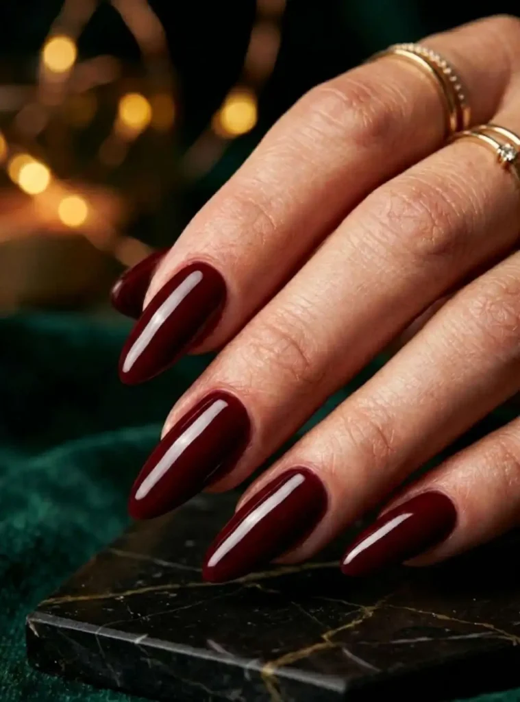 Glossy deep red almond shaped nails for a classy 30th birthday dinner look